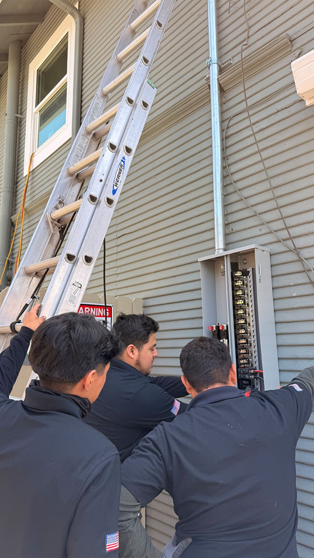 Boyes Electric electricians installing an electrical panel on a house in Stockton, CA