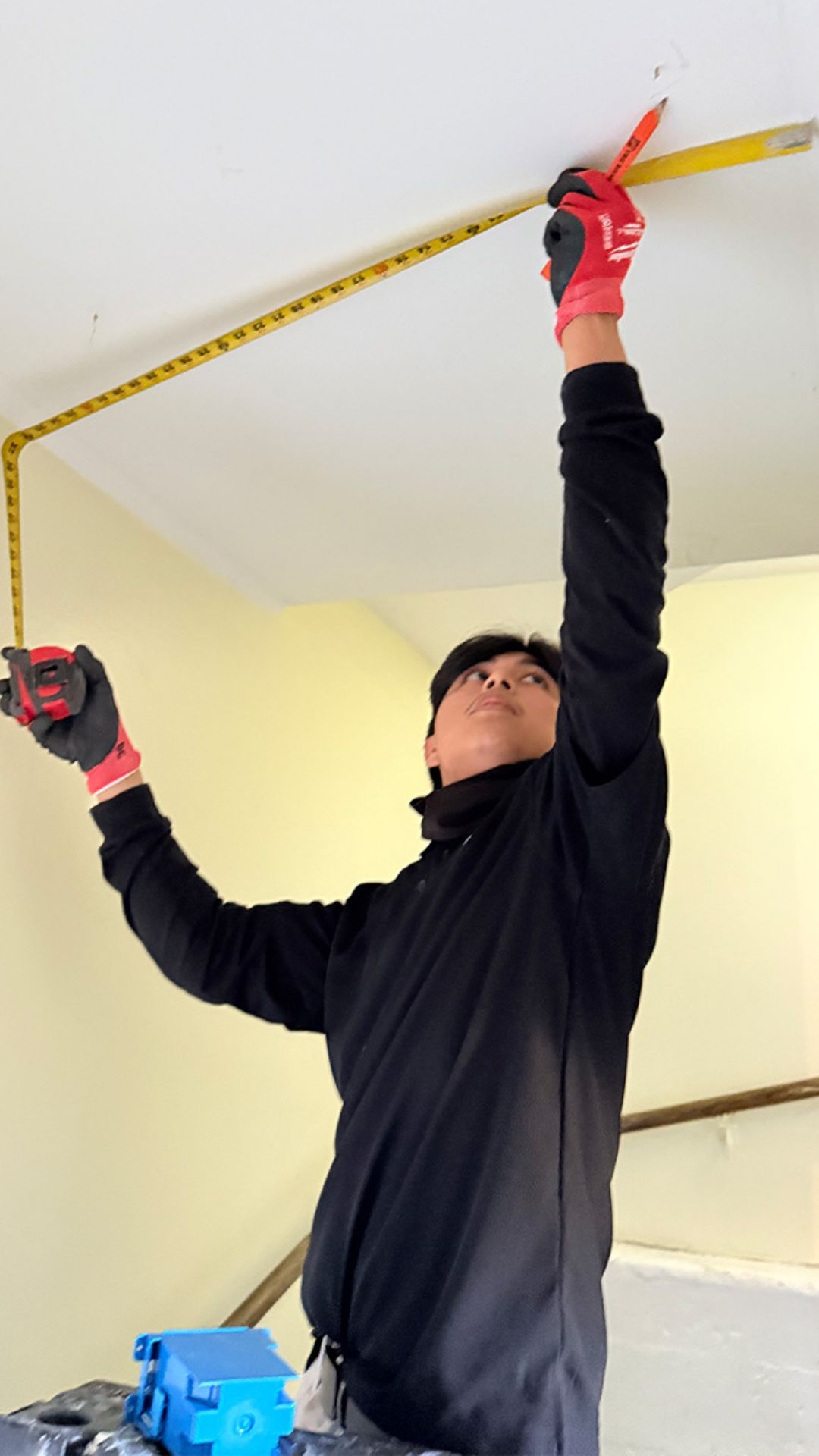 Boyes Electric electrician preparing to install a new light fixture in a Stockton, CA residence